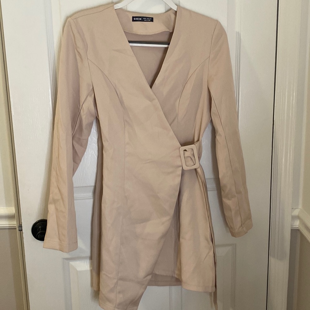 A symmetrical beige dress